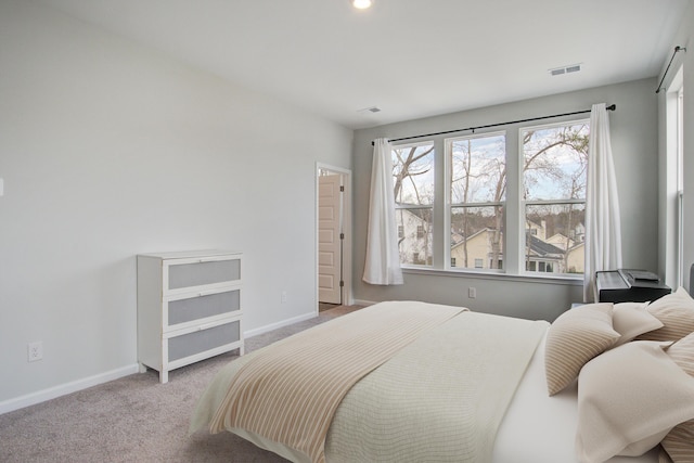 bedroom featuring visible vents, baseboards, and carpet flooring