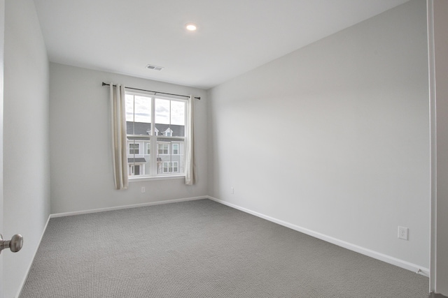 spare room featuring recessed lighting, carpet, visible vents, and baseboards