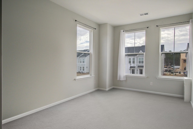 unfurnished room featuring baseboards, visible vents, and carpet flooring