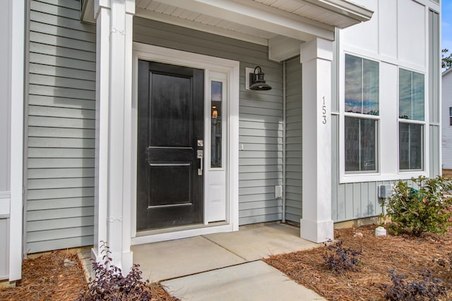 view of exterior entry featuring board and batten siding