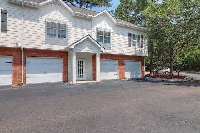 1604 Basildon Rd, Mount Pleasant, SC 29466 - townhome / multi-family property with a garage, brick siding, and driveway