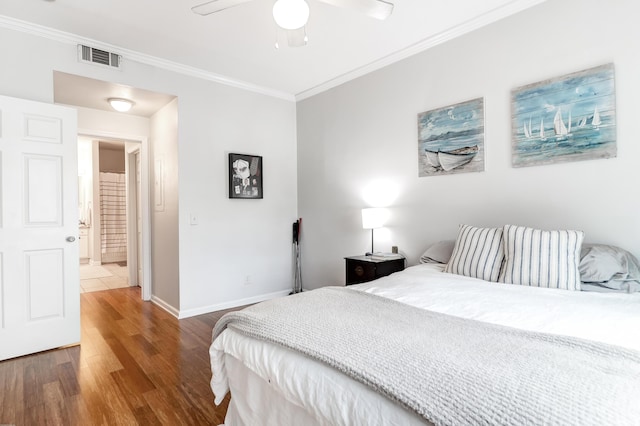 bedroom with crown molding, a ceiling fan, baseboards, and wood finished floors