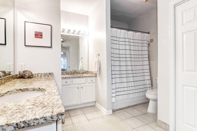 full bath with a sink, tile patterned flooring, toilet, two vanities, and a shower with curtain