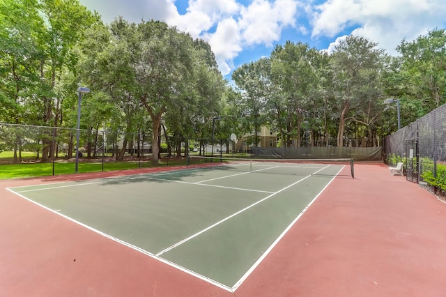 view of sport court featuring fence
