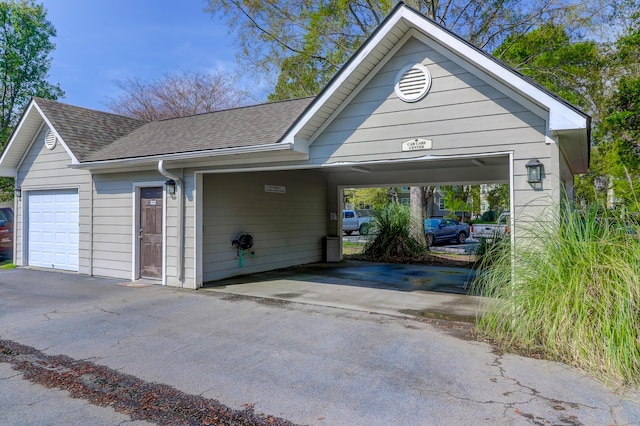 garage featuring aphalt driveway
