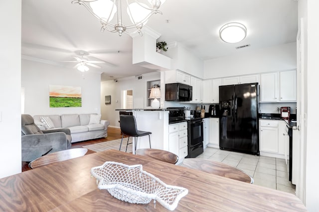 dining area featuring light tile patterned floors, ornamental molding, ceiling fan with notable chandelier, and visible vents