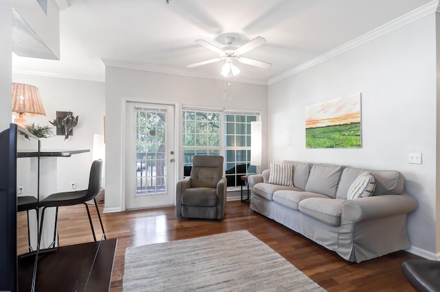living area with ceiling fan, baseboards, ornamental molding, and wood finished floors