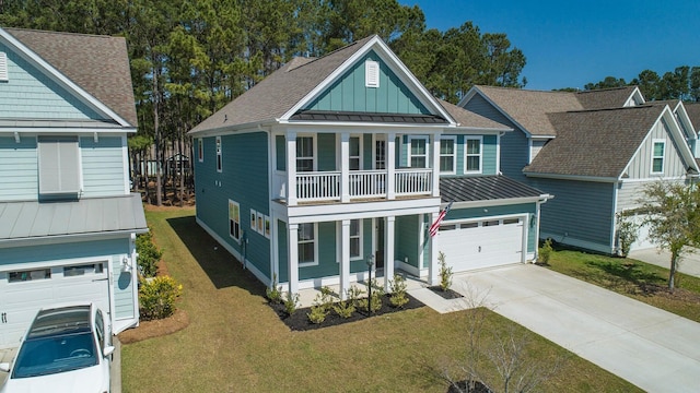 view of front of home featuring a balcony, a front lawn, and a garage