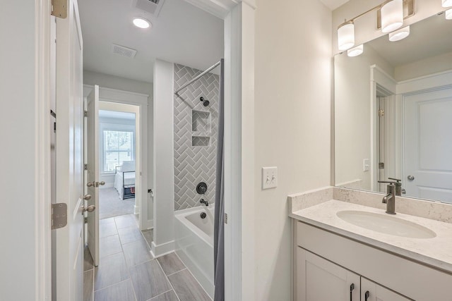 bathroom with vanity and tiled shower / bath combo