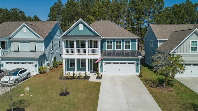 view of front of home with a balcony, a front yard, and a garage