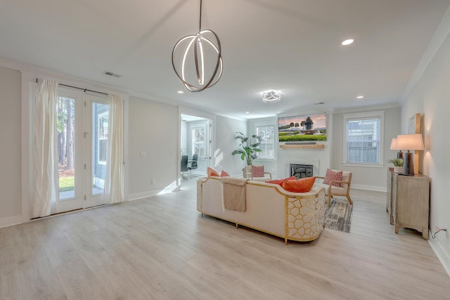 living room featuring light hardwood / wood-style floors and ornamental molding