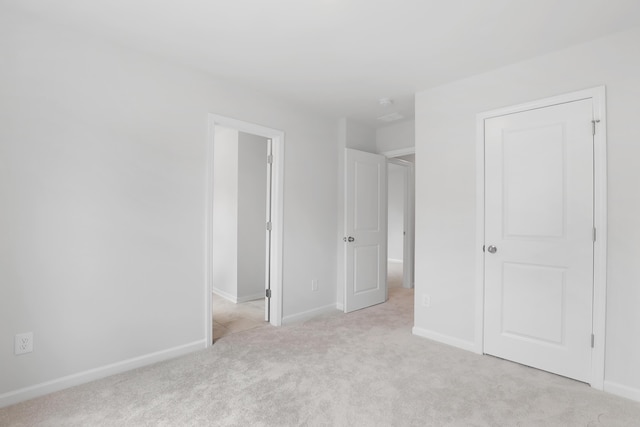 unfurnished bedroom featuring light carpet