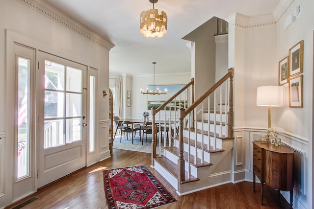 1081 Groves Manor Ct, Mount Pleasant, SC 29464 - entryway with a chandelier, wood finished floors, stairs, a decorative wall, and ornamental molding