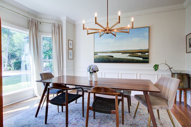 1081 Groves Manor Ct, Mount Pleasant, SC 29464 - dining area featuring ornamental molding, a chandelier, wood finished floors, a decorative wall, and wainscoting
