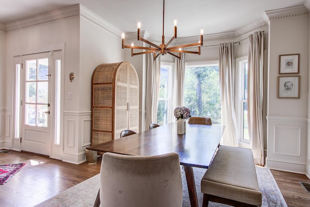 1081 Groves Manor Ct, Mount Pleasant, SC 29464 - dining room featuring a decorative wall, a chandelier, a wainscoted wall, dark wood-style floors, and ornamental molding