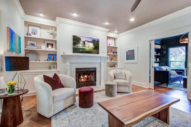 1081 Groves Manor Ct, Mount Pleasant, SC 29464 - living room featuring built in features, a lit fireplace, ornamental molding, wood finished floors, and baseboards