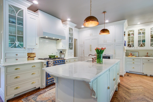 1081 Groves Manor Ct, Mount Pleasant, SC 29464 - kitchen with custom exhaust hood, stainless steel stove, a sink, white cabinetry, and recessed lighting