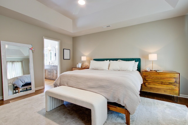 1081 Groves Manor Ct, Mount Pleasant, SC 29464 - bedroom with a raised ceiling, wood finished floors, and baseboards