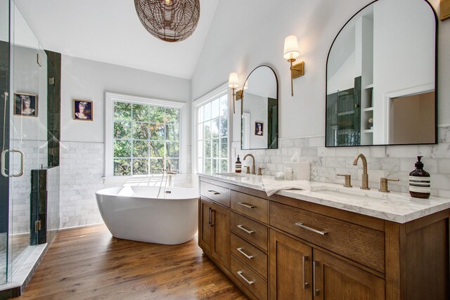 1081 Groves Manor Ct, Mount Pleasant, SC 29464 - bathroom featuring a shower stall, double vanity, a freestanding tub, high vaulted ceiling, and wood finished floors