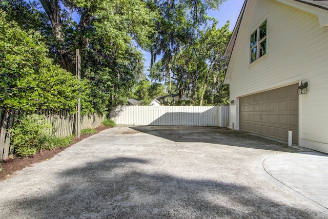 1081 Groves Manor Ct, Mount Pleasant, SC 29464 - view of yard featuring an attached garage, driveway, and fence
