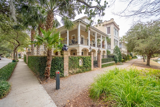 view of home's exterior featuring a balcony and ceiling fan