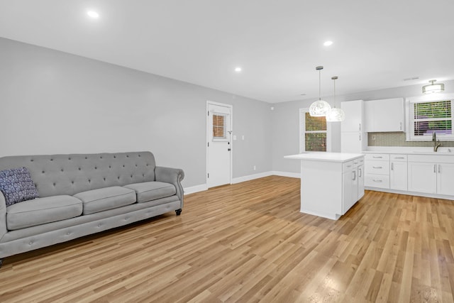 1873 Hazelwood Dr, Charleston, SC 29407 - unfurnished living room with baseboards, recessed lighting, light wood-style flooring, and a sink