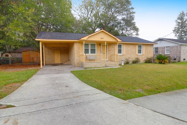 1873 Hazelwood Dr, Charleston, SC 29407 - ranch-style house with brick siding, an attached carport, concrete driveway, and a front lawn