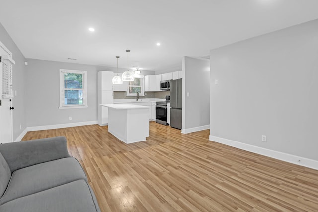 1873 Hazelwood Dr, Charleston, SC 29407 - unfurnished living room with baseboards, recessed lighting, light wood-style flooring, and a sink