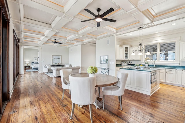104 Beach St, Mount Pleasant, SC 29464 - dining room featuring ceiling fan, light wood-style flooring, coffered ceiling, beam ceiling, and crown molding