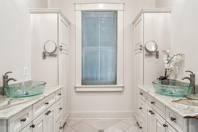 104 Beach St, Mount Pleasant, SC 29464 - bathroom featuring two vanities, baseboards, and tile patterned floors