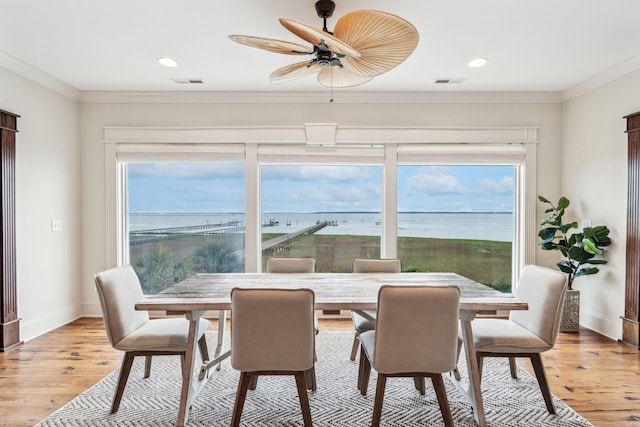 104 Beach St, Mount Pleasant, SC 29464 - dining space with light wood-style flooring, baseboards, recessed lighting, and crown molding