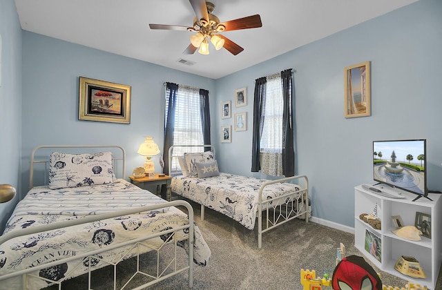 carpeted bedroom featuring visible vents, a ceiling fan, and baseboards