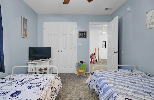 bedroom with a closet, visible vents, carpet flooring, and ceiling fan