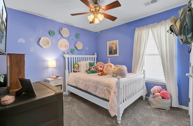 bedroom featuring visible vents, multiple windows, carpet, and ceiling fan