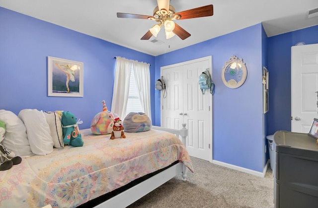 carpeted bedroom featuring visible vents, baseboards, a closet, and ceiling fan