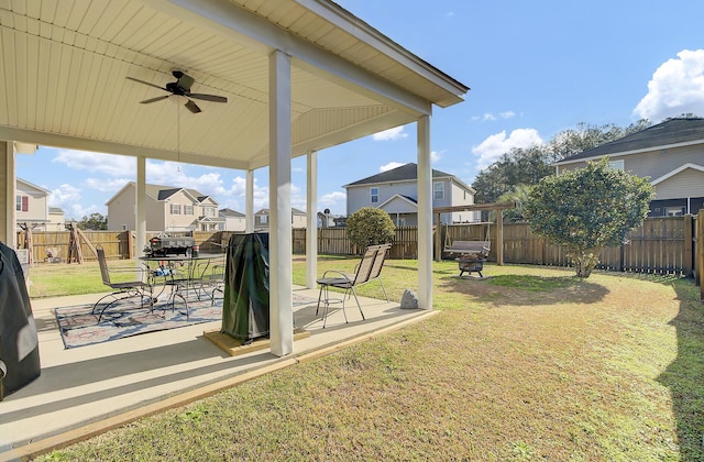 view of yard with a patio area, a residential view, a fenced backyard, and ceiling fan