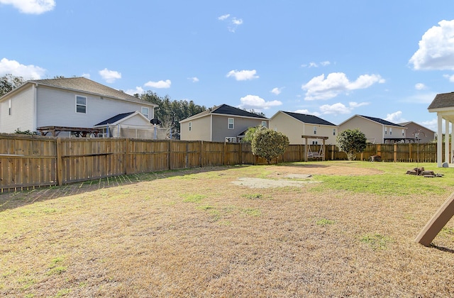 view of yard featuring a residential view and a fenced backyard