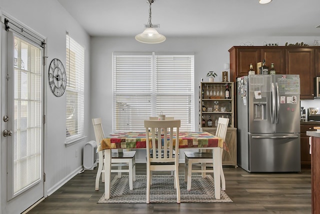 dining room featuring baseboards and dark wood-style flooring