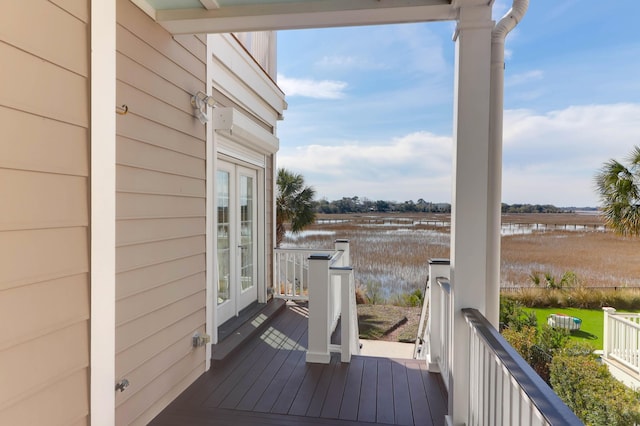 wooden deck featuring french doors and a water view