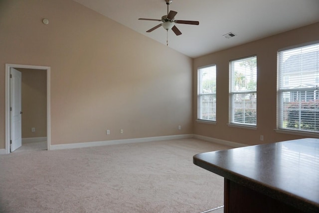 interior space featuring ceiling fan, light colored carpet, and high vaulted ceiling