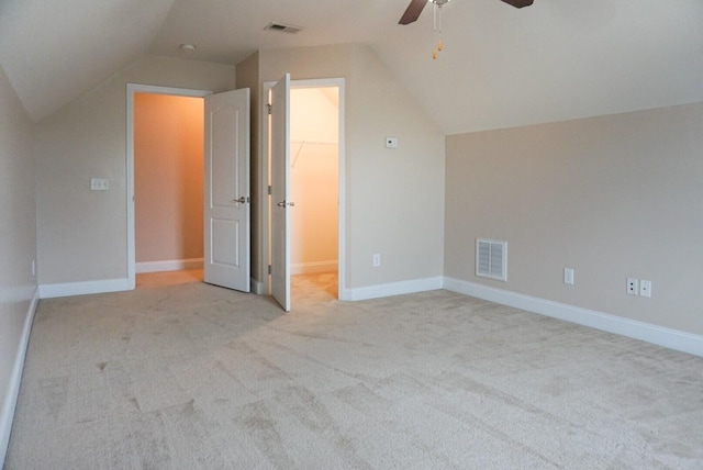 bonus room with vaulted ceiling, light colored carpet, and ceiling fan