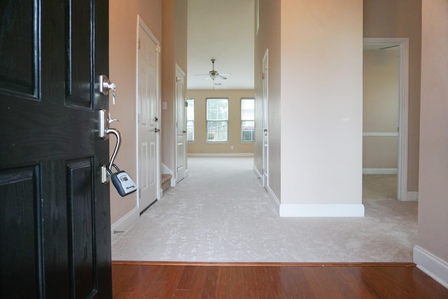 corridor with light hardwood / wood-style flooring