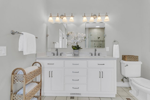 bathroom with vanity, tile patterned floors, a shower with door, and toilet