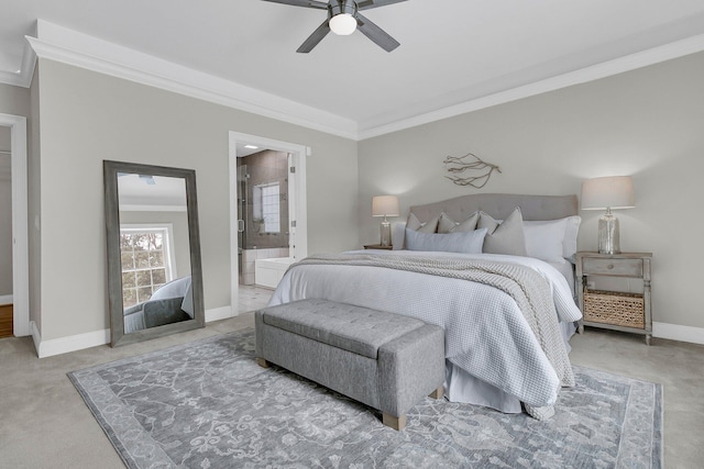 bedroom with crown molding, light carpet, ceiling fan, and ensuite bath