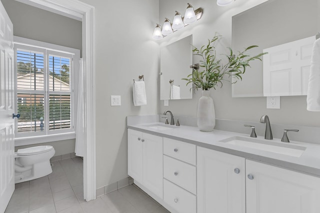 bathroom featuring vanity, tile patterned flooring, and toilet