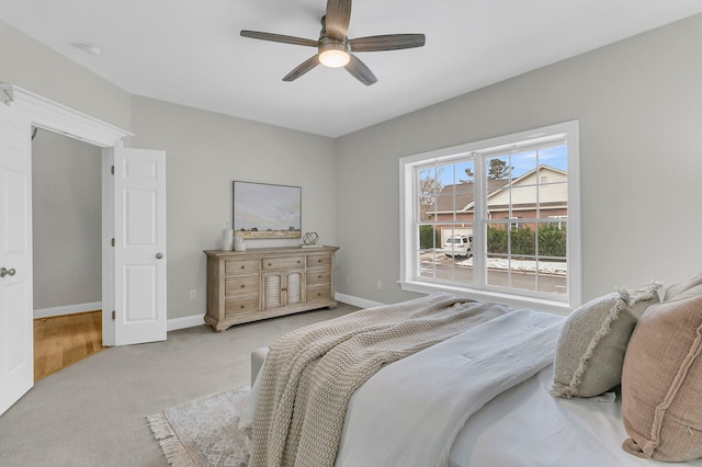 bedroom with light carpet and ceiling fan