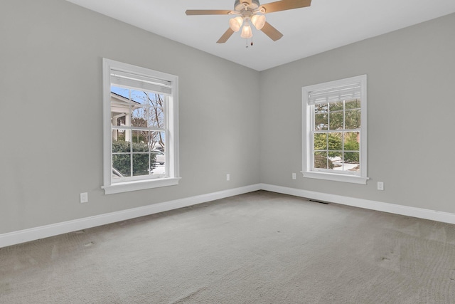 empty room featuring carpet floors and ceiling fan