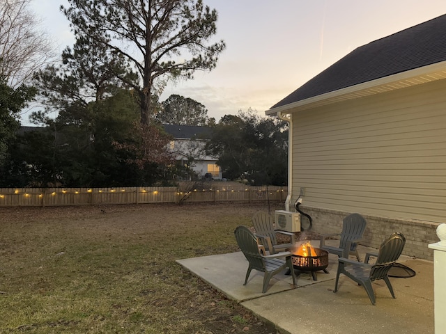 yard at dusk with a patio area and an outdoor fire pit