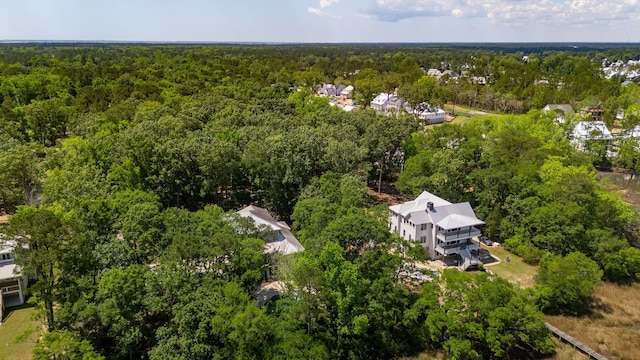 view of property location with a forest