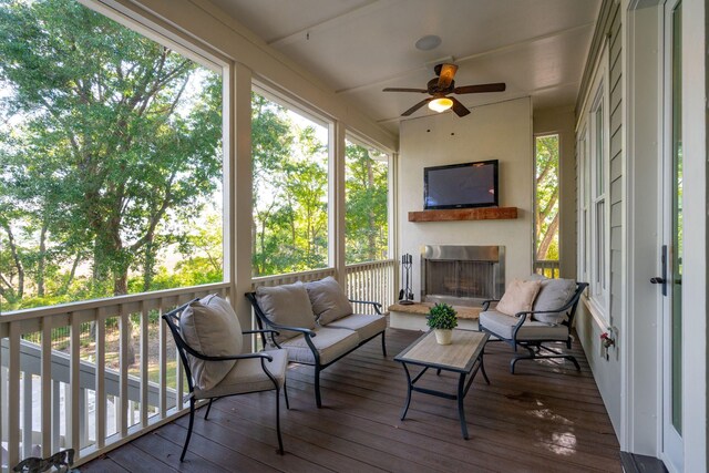 wooden terrace featuring an outdoor living space with a fireplace and ceiling fan